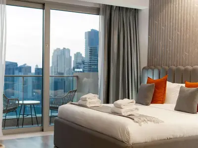 a bedroom with a bed with a view of a city at Luxury Views at The Address Dubai Marina in Dubai