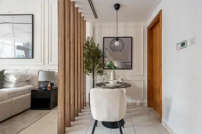 a living room with a table and a couch at GuestReady | Studio | Partial Burj Khalifa View in Dubai