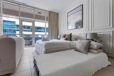 a living room with two beds and a couch at GuestReady | Studio | Partial Burj Khalifa View in Dubai