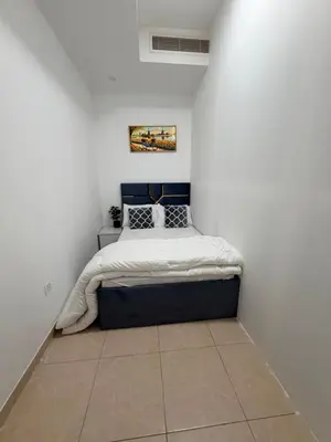 a bedroom with a bed in a white wall at Bienvenue Homes in Dubai