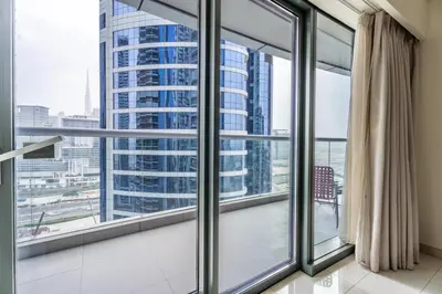a room with large windows with a view of a city at GuestReady - Chic Damac Paramount | Business Bay in Dubai