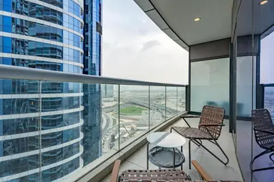 a balcony with two chairs and a table at GuestReady - Chic Damac Paramount | Business Bay in Dubai