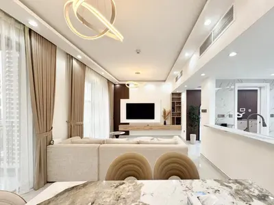 a living room with a couch and a television at Dream Shoma-2BR - Pool - Walk to Burj Khalifa in Dubai