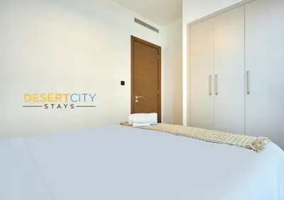 a bedroom with a bed with a sign that reads destiny stays at Stylish and Sophisticated Home Near Downtown Dubai Hosted by Desert City Stays in Dubai