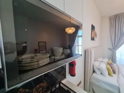 a living room with a large aquarium in a room at Fully Equipped Home near Miracle & Butterfly Gardens in Dubai