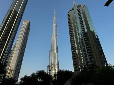 a view of the burj khalifa between two tall buildings at Burj Khalifa 1BR Pool Gym Sauna Dubai Mall in Dubai