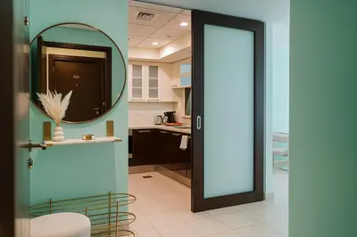 a door leading into a kitchen with a mirror at Burj Khalifa 1BR Pool Gym Sauna Dubai Mall in Dubai