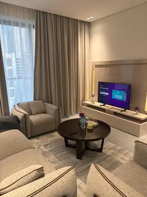 a living room with a couch and a tv at Modern Downtown 1BR Apartment in jumeirah Garden in Dubai
