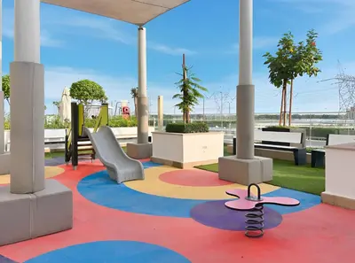 a room with a playground with a slide and a wheel at Chic Studio in Azizi Riviera Minutes to Downtown in Dubai
