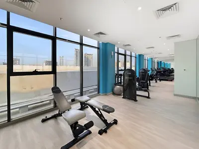a gym with treadmills and exercise equipment in a building at Chic Studio in Azizi Riviera Minutes to Downtown in Dubai