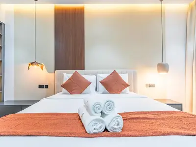 a bedroom with a white bed with towels on it at Waterfront 1BR- Time Place Dubai Marina-City Views in Dubai