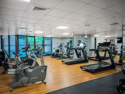 a gym with several treadmills and cardio machines at Waterfront 1BR- Time Place Dubai Marina-City Views in Dubai