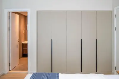 a bedroom with white cabinets and a bed at GuestReady - 1BR I Marina Walk - Canal View in Dubai