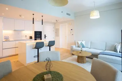 a living room with a couch and a table at GuestReady - 1BR I Marina Walk - Canal View in Dubai