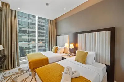 a hotel room with two beds and a large window at Nice 2 Bedroom DAMAC Uppercrest Downtown Near Dubai Mall - Partial Burj Khalifa View in Dubai