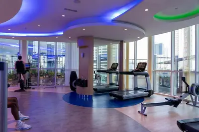 a gym with cardio equipment in a building at Nice 2 Bedroom DAMAC Uppercrest Downtown Near Dubai Mall - Partial Burj Khalifa View in Dubai