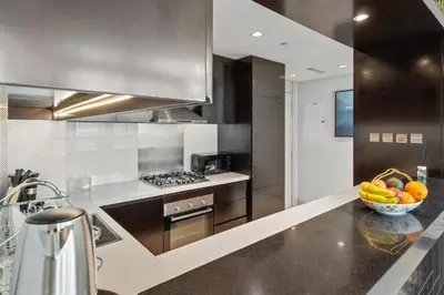 a kitchen with a bowl of fruit on a counter at Nice 2 Bedroom DAMAC Uppercrest Downtown Near Dubai Mall - Partial Burj Khalifa View in Dubai