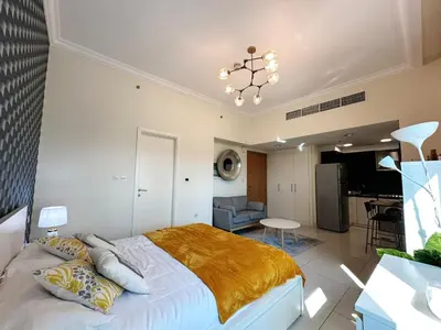 a bedroom with a bed and a living room at Modern Studio in Executive Bay Business Bay Pool, Gym with WiFi in Dubai