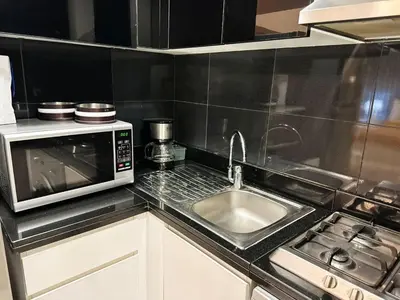 a kitchen with a sink and a microwave at Modern Studio in Executive Bay Business Bay Pool, Gym with WiFi in Dubai