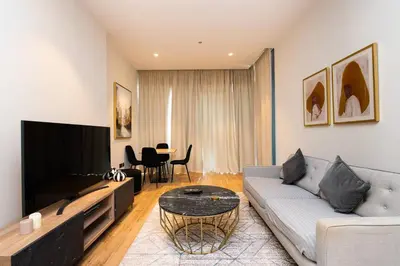 a living room with a couch and a table at CitiHome Elegant 1BR Jumeirah Living Dubai Marina in Dubai