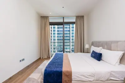 a bedroom with a large bed and a large window at CitiHome Elegant 1BR Jumeirah Living Dubai Marina in Dubai