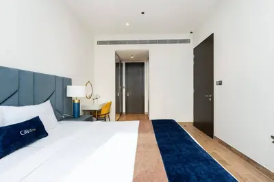 a hotel room with a bed and a desk at CitiHome Refined 1BR Jumeirah Living Marina Gate in Dubai