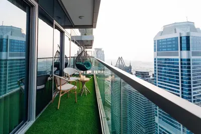 a balcony with a table and chairs on a building at Top Amenities, Luxury 2BR, 5 min. to Burj Khalifa in Dubai