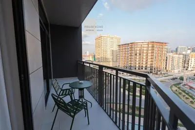 a balcony with two chairs and a table on it at Luxurious chic getaway for 4, pool view, hammam, sauna, PS5 in Dubai