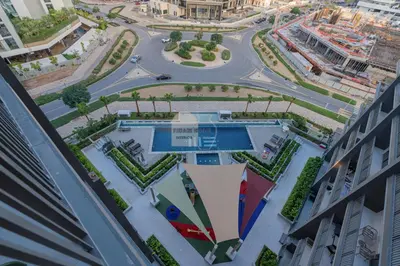 an aerial view of a city with a pool at Luxurious chic getaway for 4, pool view, hammam, sauna, PS5 in Dubai