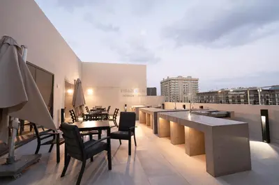 a balcony with a table and chairs on a building at Luxurious chic getaway for 4, pool view, hammam, sauna, PS5 in Dubai