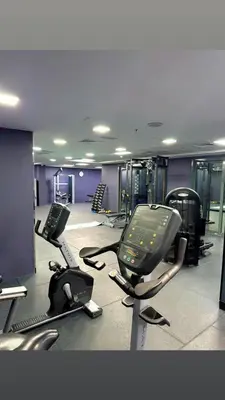 a gym with several treadmills and exercise bikes at Ruby home in Dubai