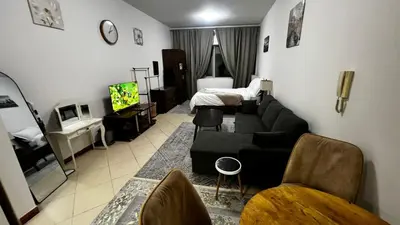 a living room with a couch and a bed at Dream home in Dubai