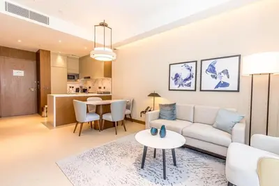 a living room with a couch and a table at 3BR with Full Burj Khalifa and Dubai Fountain View at Address Opera in Dubai