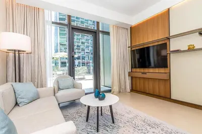 a living room with a couch and a tv at 3BR with Full Burj Khalifa and Dubai Fountain View at Address Opera in Dubai