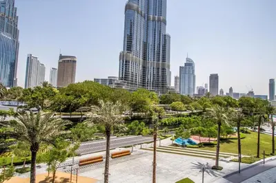 a park in a city with tall buildings at 3BR with Full Burj Khalifa and Dubai Fountain View at Address Opera in Dubai