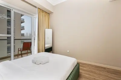 a bedroom with a large white bed and a window at Modern 1BR Unit Close to Canal Walk & Burj Khalifa in Dubai