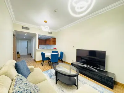 a living room with a couch and a table at Upgraded Sea View 1BR Dubai Marina, Walk Metro & JBR in Dubai