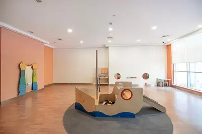 a large room with a slide in the middle of it at Boulevard Chic Modern 2BR with Iconic Street Views in Dubai