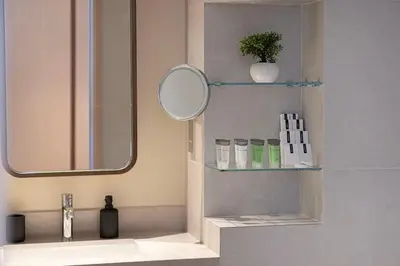 a bathroom with a sink with a mirror and a mirrorcil at Iconic Living Contemporary 2BR at Vida Dubai Mall in Dubai