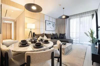 a living room with a table and a couch at Iconic Living Contemporary 2BR at Vida Dubai Mall in Dubai