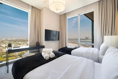 a hotel room with two beds and a large window at Iconic Living Contemporary 2BR at Vida Dubai Mall in Dubai