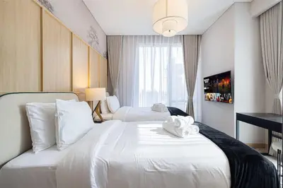 a hotel room with two beds with towels on them at Heart of Downtown Stylish 2BR at Vida Dubai Mall in Dubai