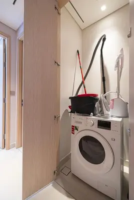 a kitchen with a washing machine in a room at Heart of Downtown Stylish 2BR at Vida Dubai Mall in Dubai