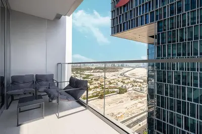 a balcony with chairs and a view of a city at Heart of Downtown Stylish 2BR at Vida Dubai Mall in Dubai