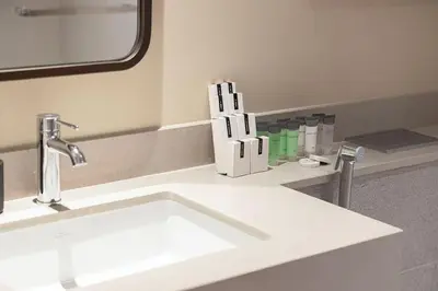 a bathroom with a white sink and a mirror at Heart of Downtown Stylish 2BR at Vida Dubai Mall in Dubai