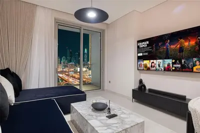 a living room with a couch and a large window at Downtown Living Massive 4BR at Vida Dubai Mall in Dubai
