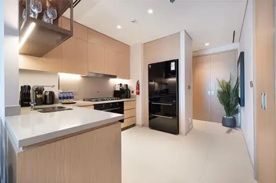a kitchen with a sink and a stove top oven at Downtown Living Massive 4BR at Vida Dubai Mall in Dubai
