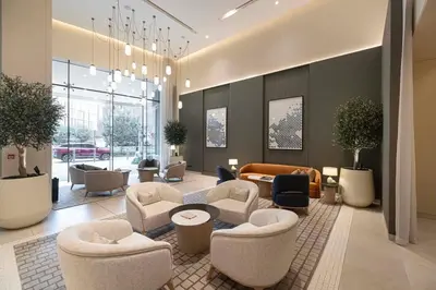 a lobby with couches and chairs in a building at Downtown Living Massive 4BR at Vida Dubai Mall in Dubai