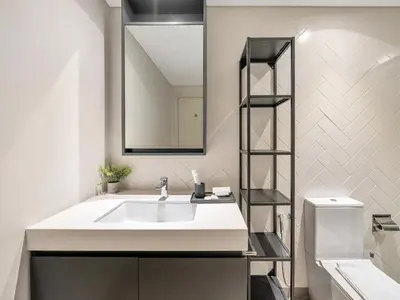 a bathroom with a white sink and a mirror at Royal Vista - 1BR with Darts Wall at Belgravia Square JVC in Dubai