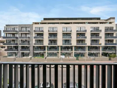 a large apartment building in front of a building at Royal Vista - 1BR with Darts Wall at Belgravia Square JVC in Dubai